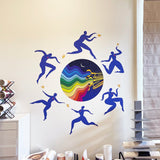 A colorful Jazzy Night Decal by Cover-Alls in a room, featuring silhouetted dancers around a vibrant circle with a cosmic and rainbow design, inspired by the New Orleans Jazz Fest.
