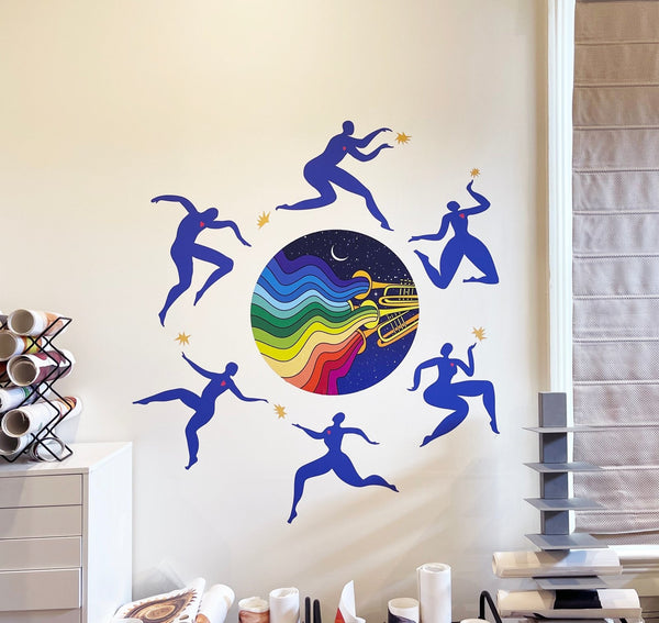 A colorful Jazzy Night Decal by Cover-Alls in a room, featuring silhouetted dancers around a vibrant circle with a cosmic and rainbow design, inspired by the New Orleans Jazz Fest.