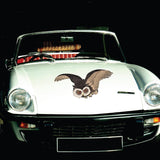 A white Woodblock Owl sports car made by CoverAlls, featuring a Halloween themed decal.